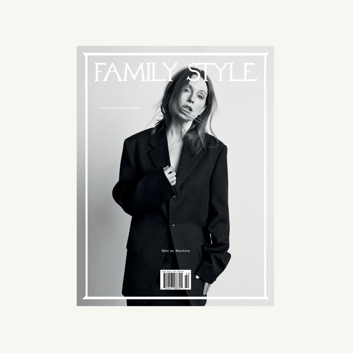 Woman in oversized suit on Family Style Magazine cover, neutral background.