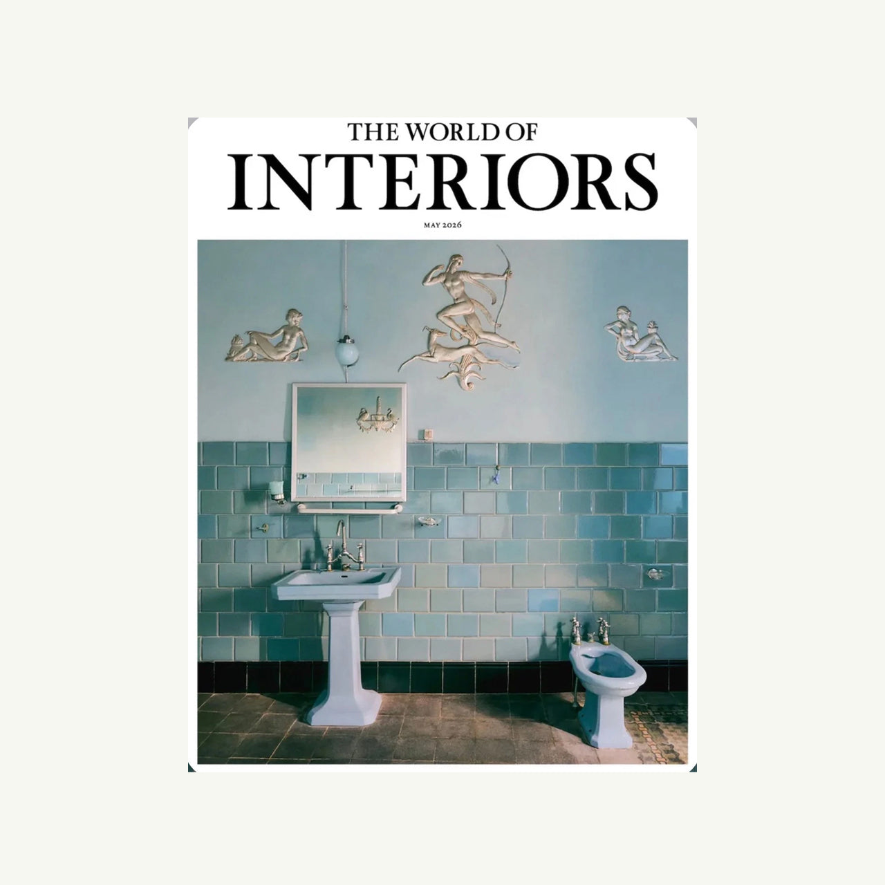 A bathroom with blue tiles, sink, bidet, mirror & The World of Interiors by NJ Penn Logistics.