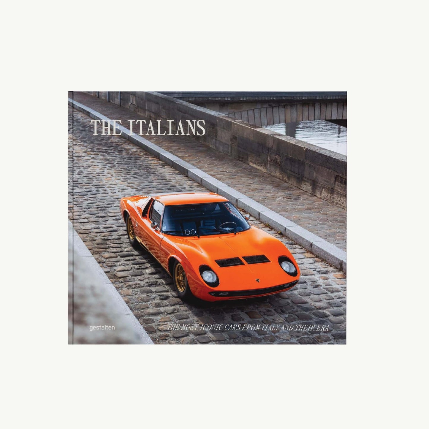 An orange vintage car on cobblestones, cover titled The Italians – Beautiful Machines by Gestalten.