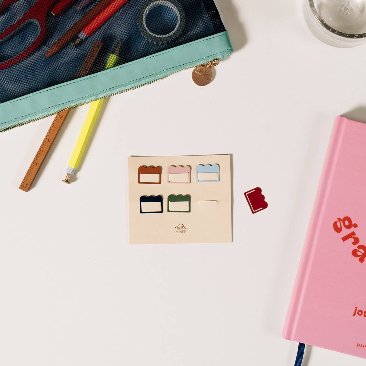 Papier Metal Index Tabs in cloud shapes sit with stationery on a white desk and pink journal.