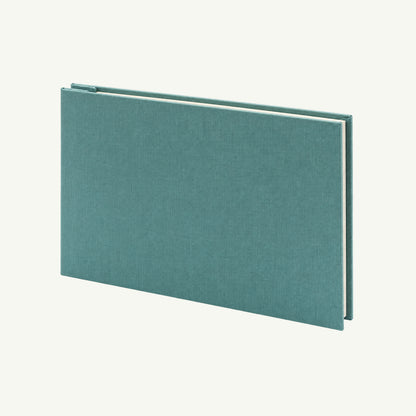 Teal Linen Post Photo Album by Orange Art rests closed on a plain background, cream pages inside.