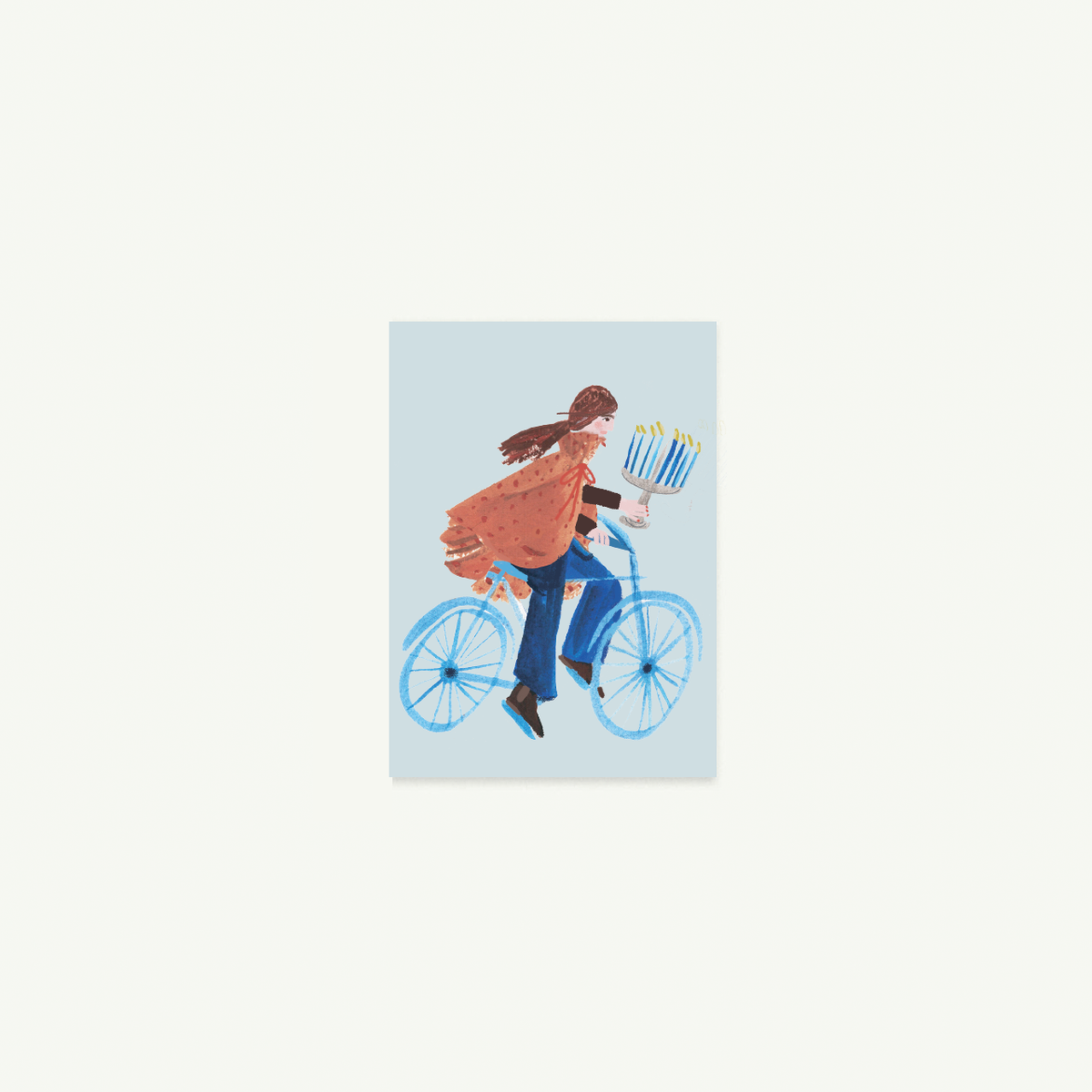 Person rides blue bike with gifts, menorah—Biking You Light Petite Card by Mr. Boddington’s Studio.