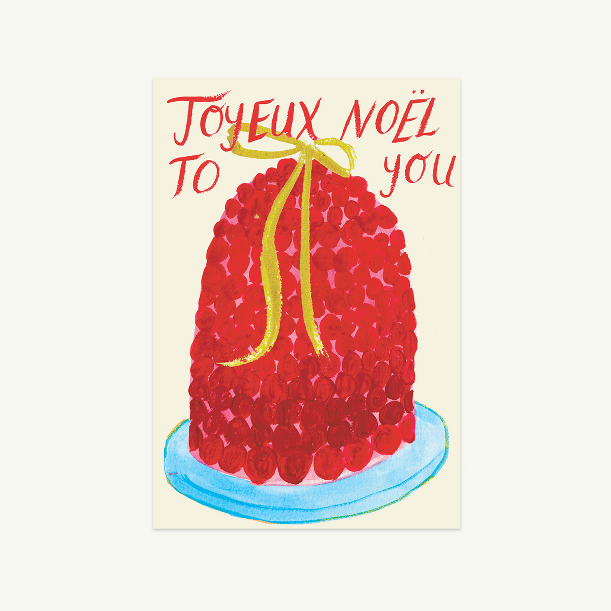 Joyeux Noel cake by Mr. Boddington’s Studio, with yellow ribbon on blue plate.