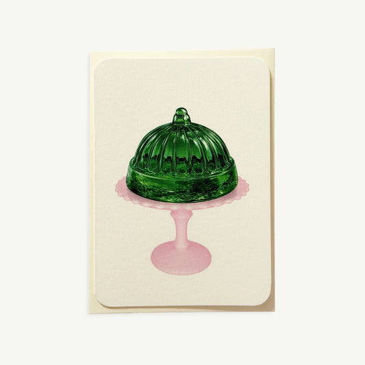 Canonbury Press Emerald Jelly Greeting Card: green glass dome cake on pink stand, white background.