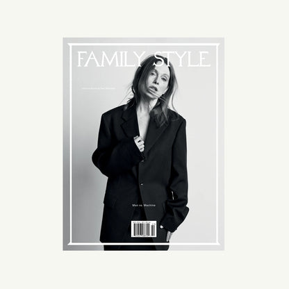 Woman in oversized suit on Family Style Magazine cover, neutral background.
