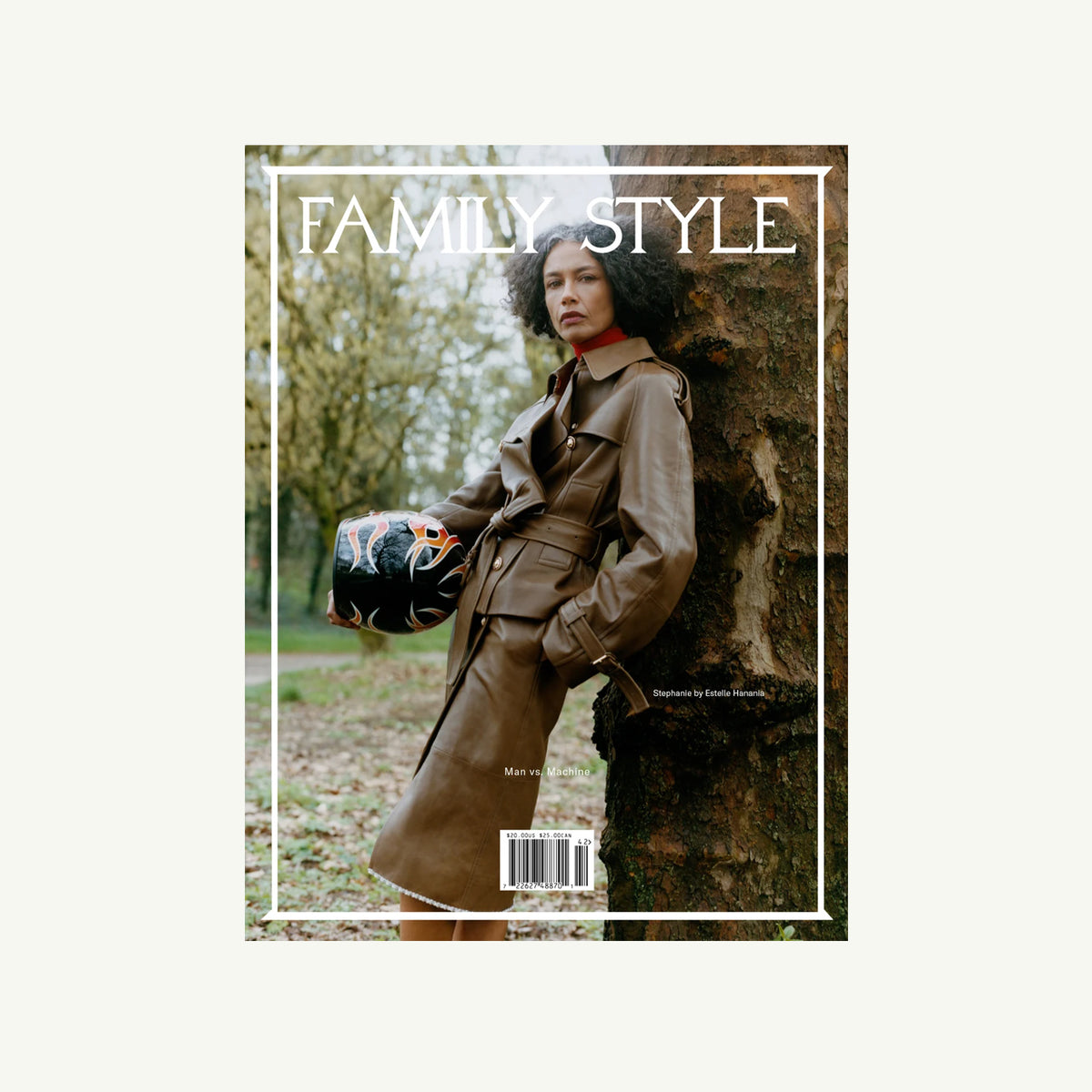 Woman in brown trench with black helmet, outdoors, holding Family Style Magazine by Family Style.