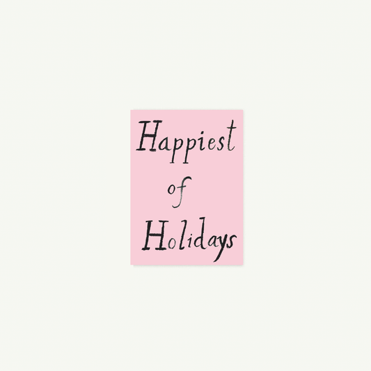 Happiest of Holidays petite card by Mr. Boddington’s Studio in pink with black script.