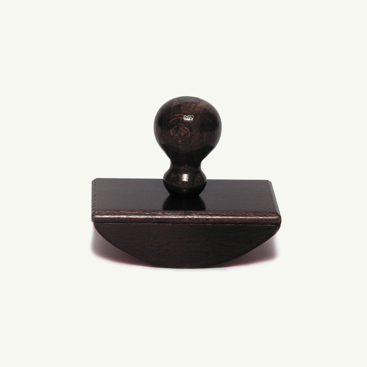 Herbin Wooden Rocker-Style Ink Blotter: a dark wooden rocker-style blotter with a round handle.