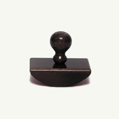 Herbin Wooden Rocker-Style Ink Blotter: a dark wooden rocker-style blotter with a round handle.