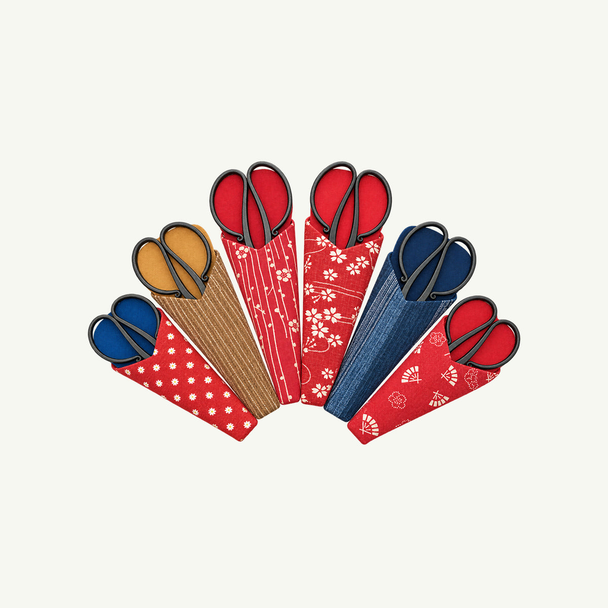 Six IKNM Tanebasami Scissors in patterned fabric sheaths arranged in a fan shape.