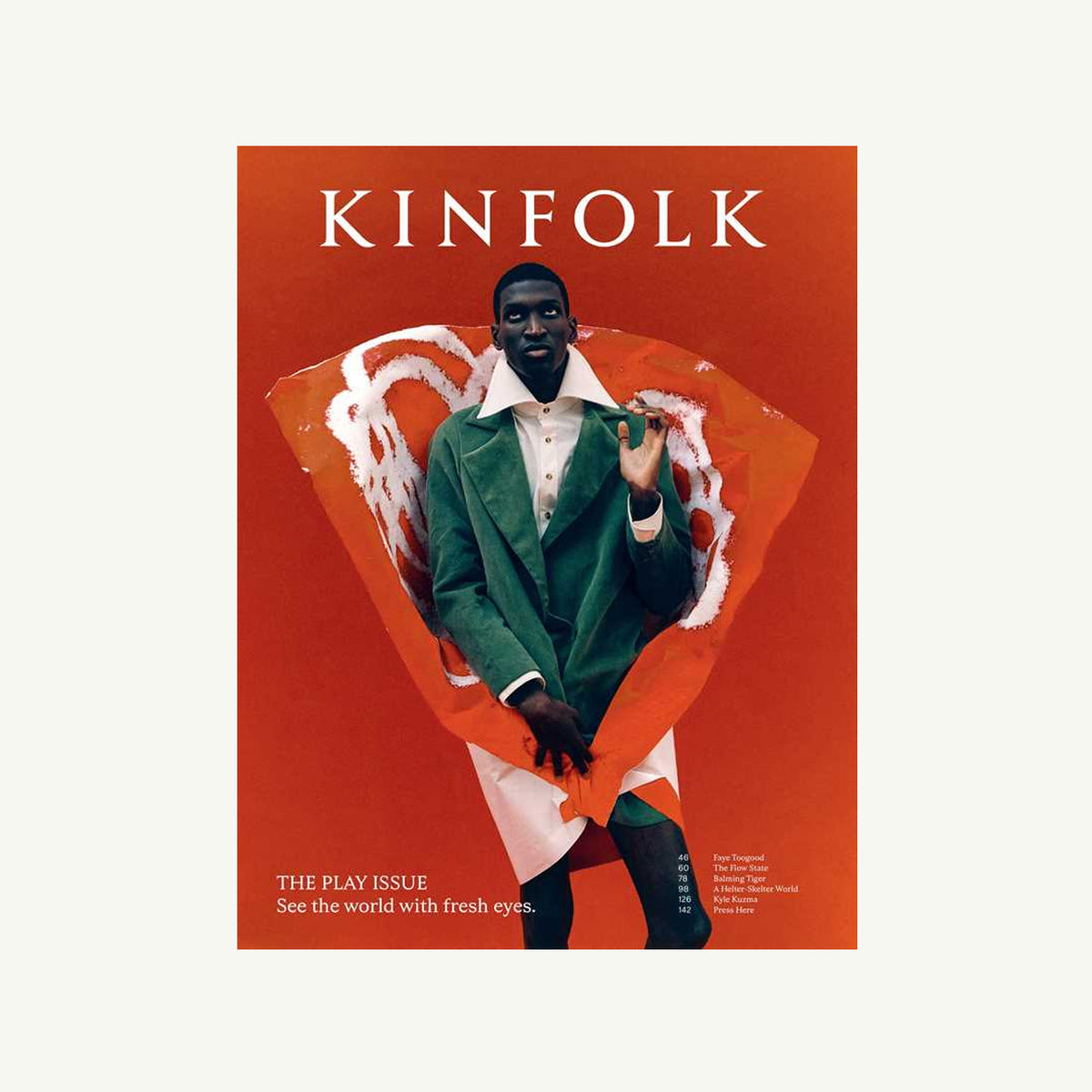 Person in green coat on red Kinfolk Magazine cover by Simon & Schuster; modern, artistic style.