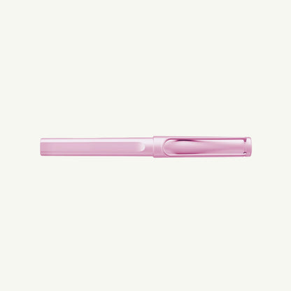 A closed, light pink Lamy Safari Rollerball pen with a comfy grip on a white background.
