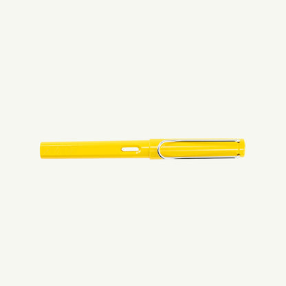 Yellow Lamy Safari Fountain Pen, Fine, with steel nib and silver clip on white background.