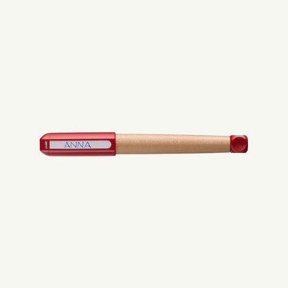 Wooden Lamy ABC Fountain Pen, ergonomic grip, red cap, labeled ANNA on white background.