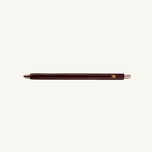 Le Typographe dark brown hexagonal mechanical pencil with gold accents and sharpener.