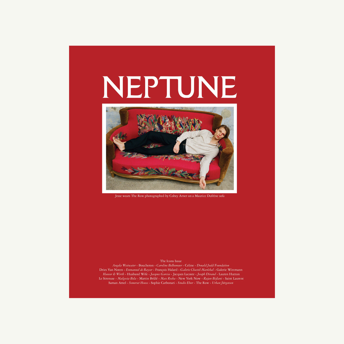 Person on sofa, Neptune by Neptune Papers above—cinematic style meets standout interiors.