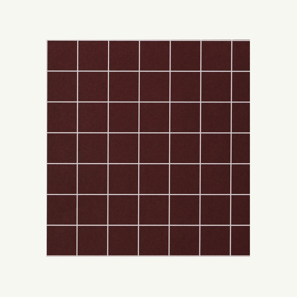 Kinshipped Recycled Gift Wrap: a grid of dark brown tiles with white grout on white background.