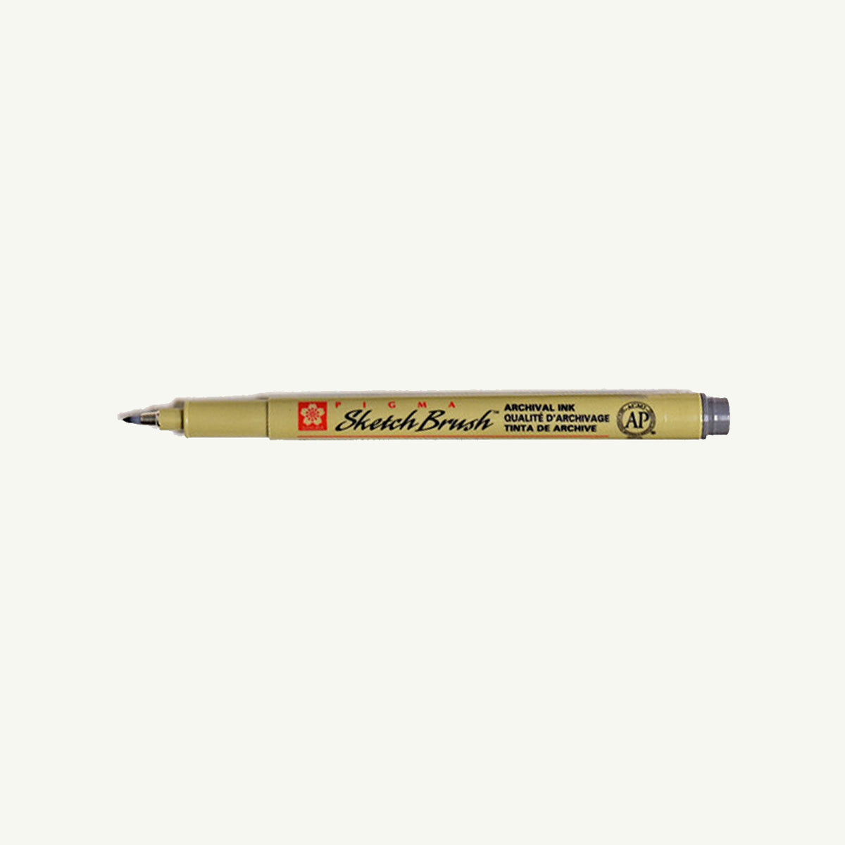Sakura Pigma Sketch Pen in tan with black tip, shown lying horizontally on a white background.
