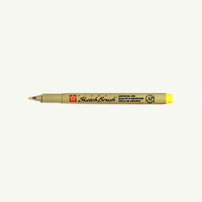 Sakura Pigma Sketch Pen in sepia with yellow cap, displayed on a plain background.