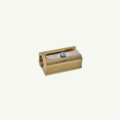 Sweet Bella Single Block Brass Sharpener with metal blade, angled view on plain background.