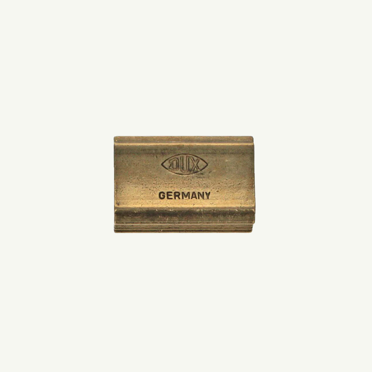 Single Block Brass Sharpener by Sweet Bella on a plain light background.