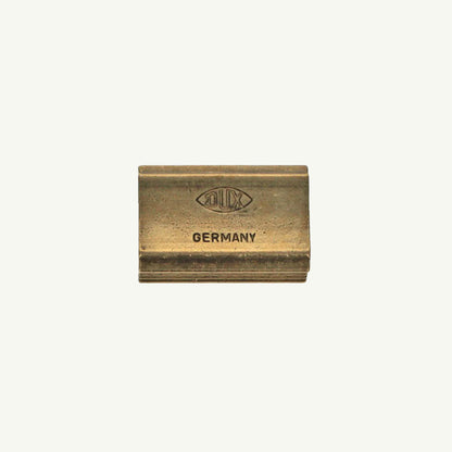 Single Block Brass Sharpener by Sweet Bella on a plain light background.