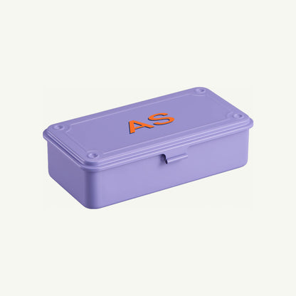 A lilac Toyo Steel Monogrammed Storage Box with AS in orange on the lid.