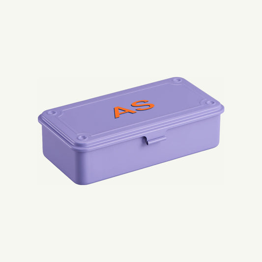 A lilac Toyo Steel Monogrammed Storage Box with AS in orange on the lid.