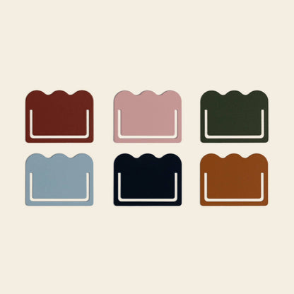 Six metal cloud-shaped tabs from Papier add color as stationery or markers on a cream background.