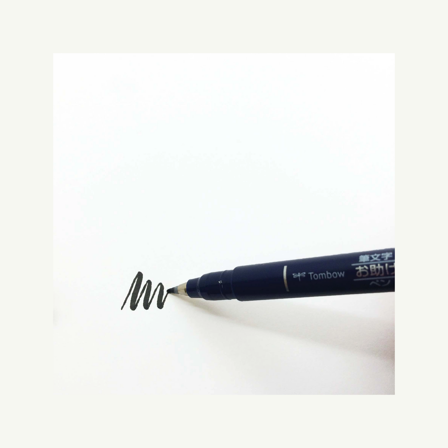 Tombow Calligraphy Brush Pen draws zigzags on white paper, perfect for lettering and calligraphy.